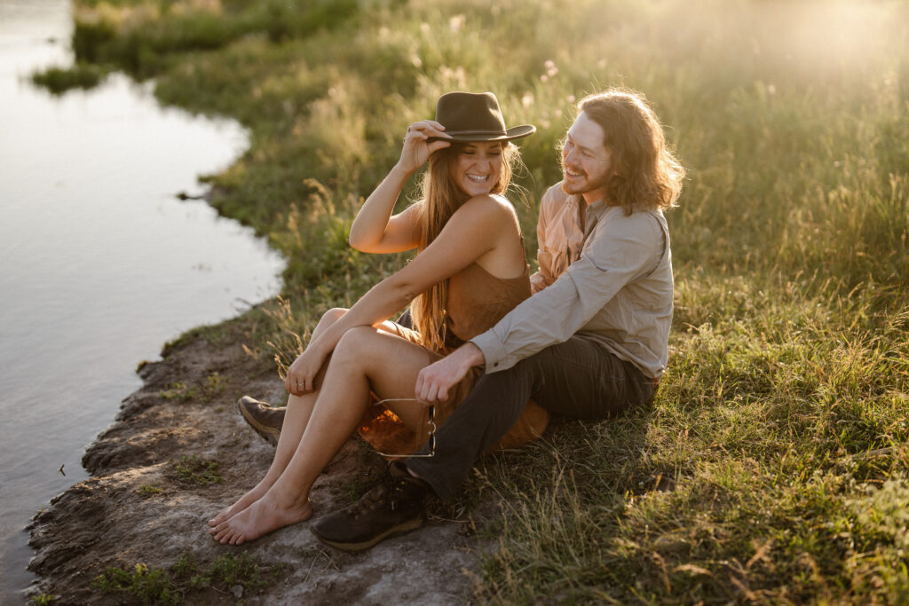 Two copywriters sit on the banks of an Oregon river, laughing and discussing copywriting strategy.