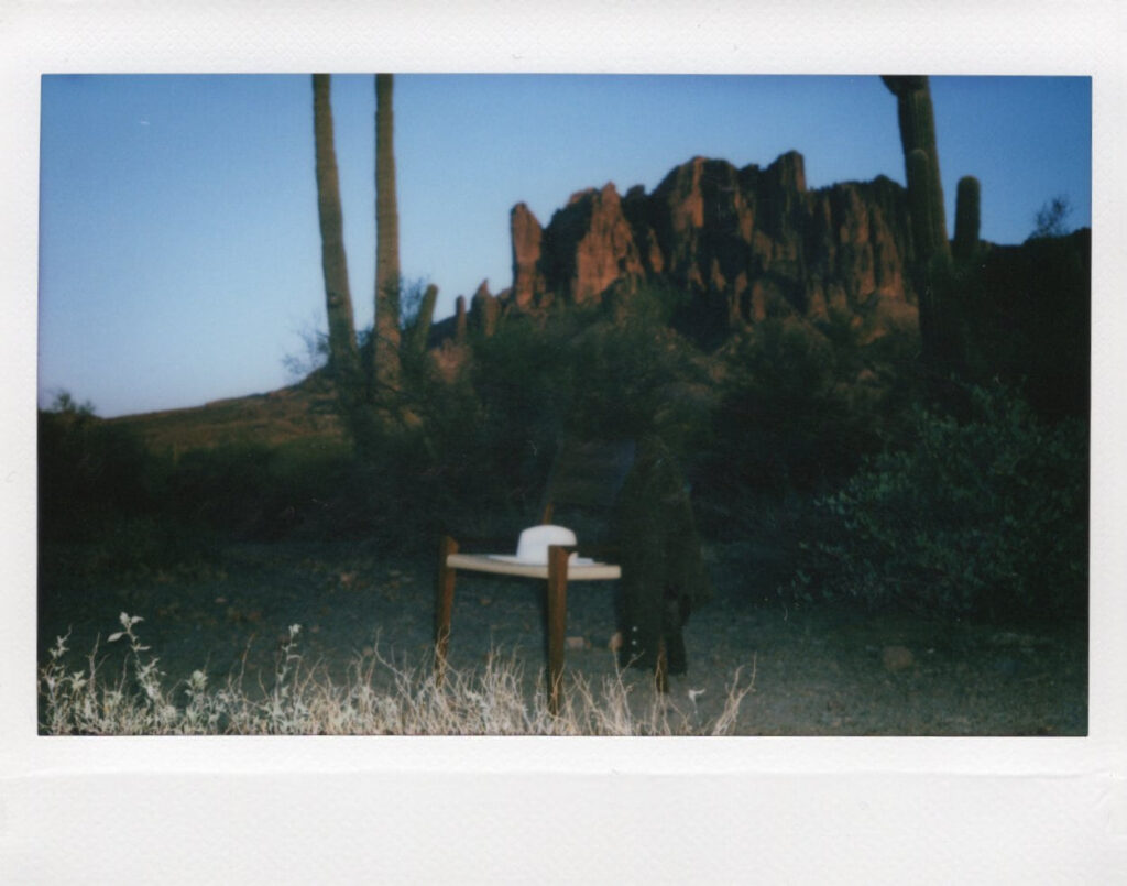 An empty chair in the desert holds a laptop where a copywriter creates strategic copywriting.